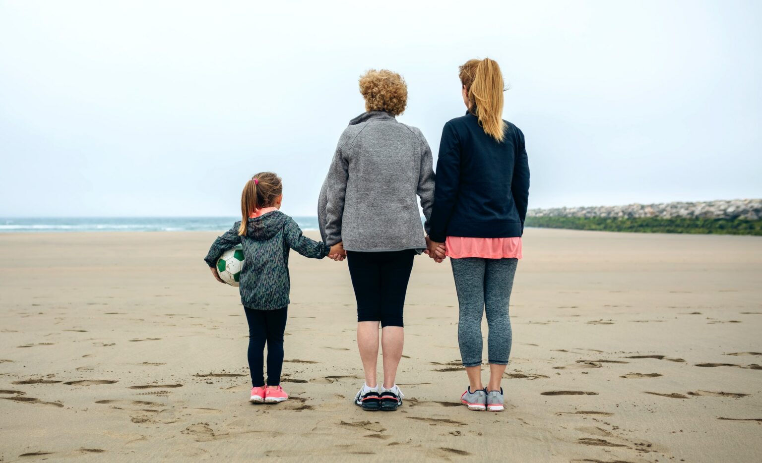 Three generations female watching the sea